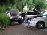 Helping out a new found friend with a lincoln Navigator dead battery at Furnace Creek Ranch motel. P2180292.JPG